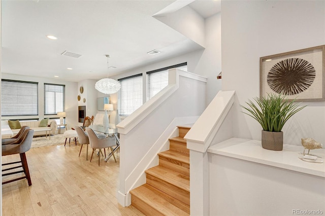 stairs featuring hardwood / wood-style flooring