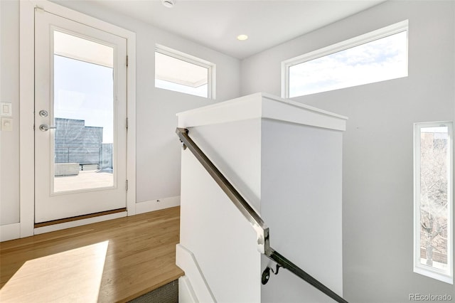 staircase with hardwood / wood-style floors