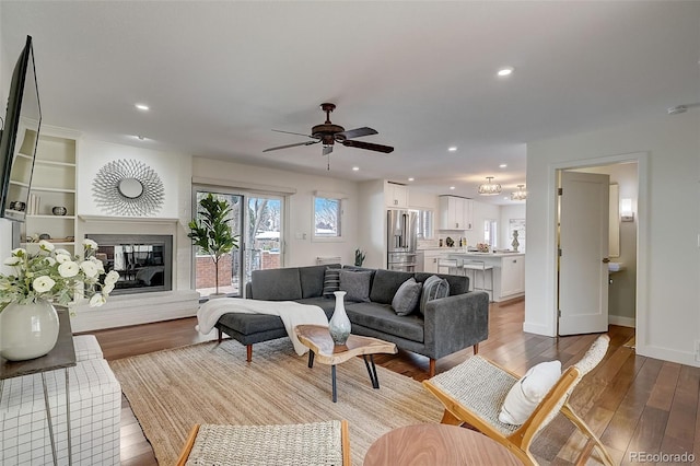 3434 S Race St, Englewood, CO 80113 - living area featuring light wood-style floors, a ceiling fan, recessed lighting, and a glass covered fireplace