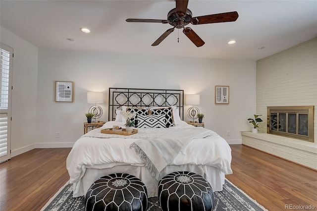 3434 S Race St, Englewood, CO 80113 - bedroom featuring wood finished floors, recessed lighting, a ceiling fan, and a fireplace