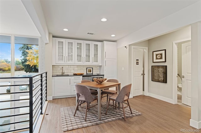 3434 S Race St, Englewood, CO 80113 - dining area featuring light wood-type flooring, bar with sink, and recessed lighting