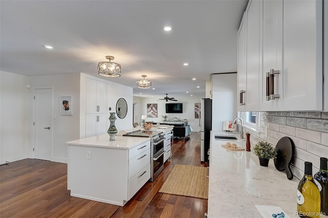 3434 S Race St, Englewood, CO 80113 - kitchen with appliances with stainless steel finishes, open floor plan, a center island, a chandelier, and dark wood-style floors