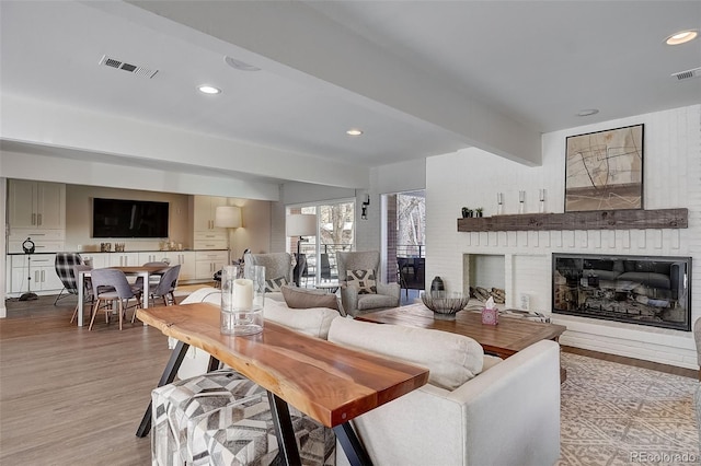 3434 S Race St, Englewood, CO 80113 - living area with light wood-style flooring, a fireplace, recessed lighting, and beamed ceiling