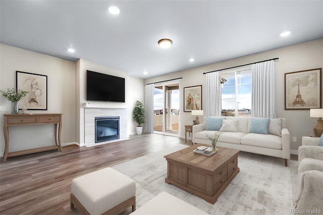 22394 E 49th Pl, Aurora, CO 80019 - living area with light wood-type flooring, a glass covered fireplace, and recessed lighting