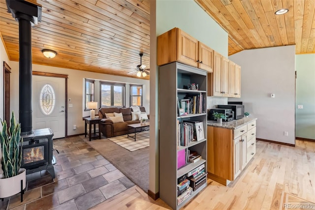 16651 Holly Ct, Buena Vista, CO 81211 - kitchen with wooden ceiling, a wood stove, vaulted ceiling, baseboards, and ceiling fan