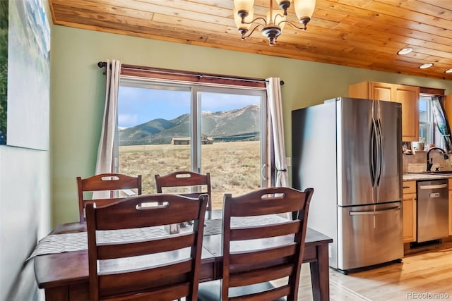 16651 Holly Ct, Buena Vista, CO 81211 - dining area featuring wood ceiling, a mountain view, a chandelier, plenty of natural light, and light wood finished floors