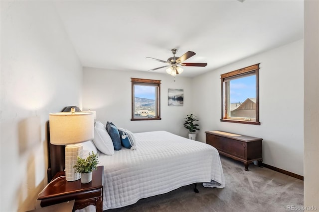 16651 Holly Ct, Buena Vista, CO 81211 - carpeted bedroom featuring multiple windows, baseboards, and ceiling fan