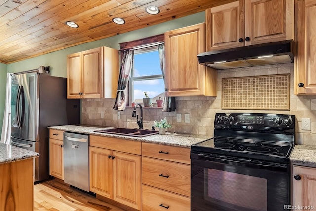 16651 Holly Ct, Buena Vista, CO 81211 - kitchen featuring stainless steel appliances, under cabinet range hood, light wood-style floors, light stone counters, and backsplash
