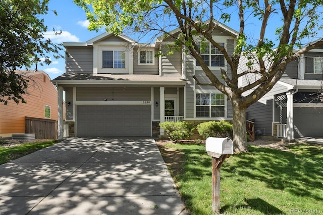 9690 Lansing Cir, Commerce City, CO 80022 - traditional-style home featuring a garage, concrete driveway, roof with shingles, and stone siding