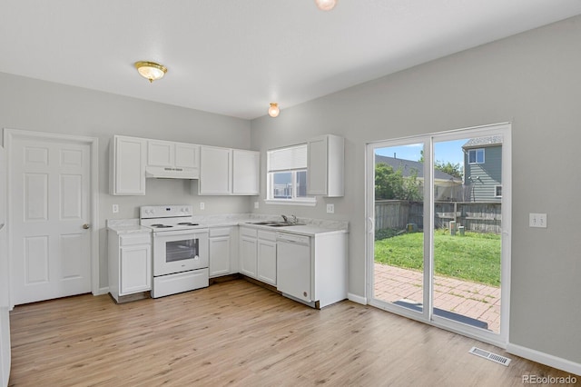 9690 Lansing Cir, Commerce City, CO 80022 - kitchen with white appliances, under cabinet range hood, light countertops, and white cabinetry