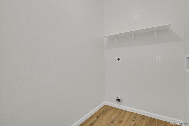 9690 Lansing Cir, Commerce City, CO 80022 - clothes washing area featuring hookup for an electric dryer, light wood-type flooring, and baseboards