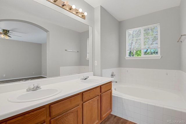 9690 Lansing Cir, Commerce City, CO 80022 - bathroom with a ceiling fan, a garden tub, double vanity, and wood finished floors