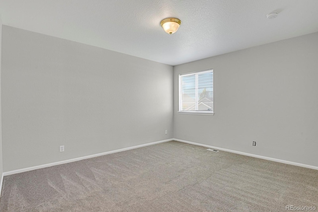 9690 Lansing Cir, Commerce City, CO 80022 - empty room with carpet flooring, a smoke detector, baseboards, and a textured ceiling