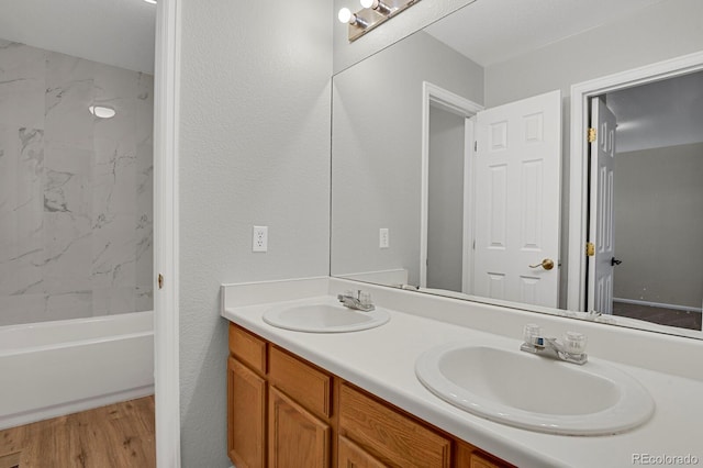 9690 Lansing Cir, Commerce City, CO 80022 - bathroom with double vanity, wood finished floors, and shower / bathtub combination
