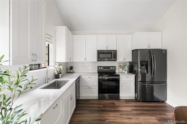 5991 W 68th Ave, Arvada, CO 80003 - kitchen featuring stainless steel appliances, a sink, light countertops, white cabinets, and lofted ceiling