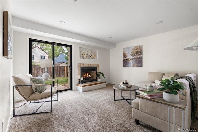 5991 W 68th Ave, Arvada, CO 80003 - living area with carpet flooring, a tiled fireplace, and baseboards