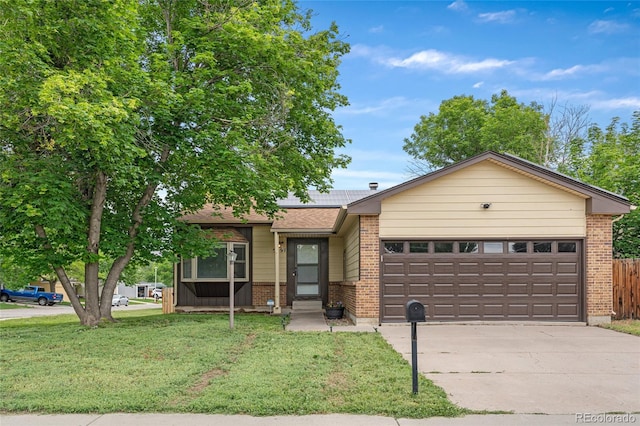 5991 W 68th Ave, Arvada, CO 80003 - view of front of house featuring a garage, driveway, brick siding, and solar panels