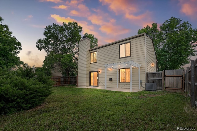 5991 W 68th Ave, Arvada, CO 80003 - back of property at dusk with a pergola, a chimney, and a patio