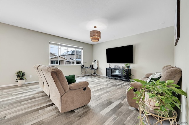 living room featuring light wood-style flooring and baseboards