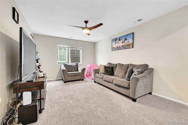 living room with a ceiling fan, light colored carpet, visible vents, and baseboards