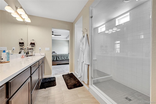 bathroom with ensuite bathroom, tile patterned flooring, vanity, a ceiling fan, and walk in shower