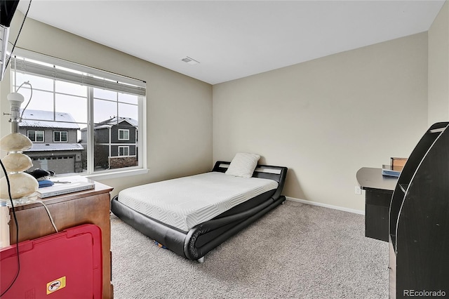 bedroom featuring light carpet, visible vents, and baseboards