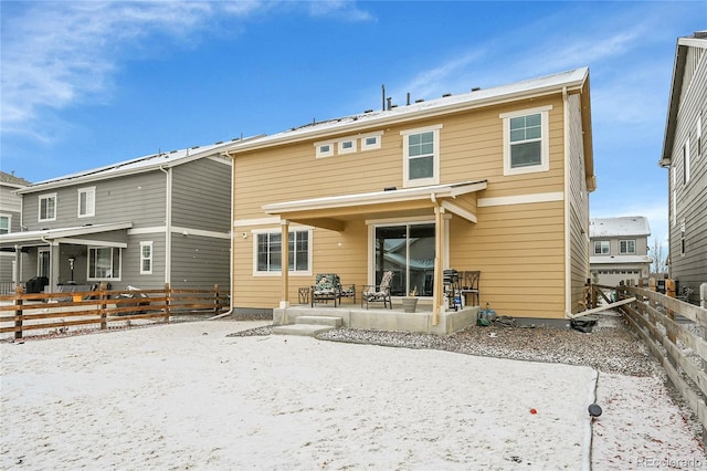 rear view of property featuring a patio area and fence