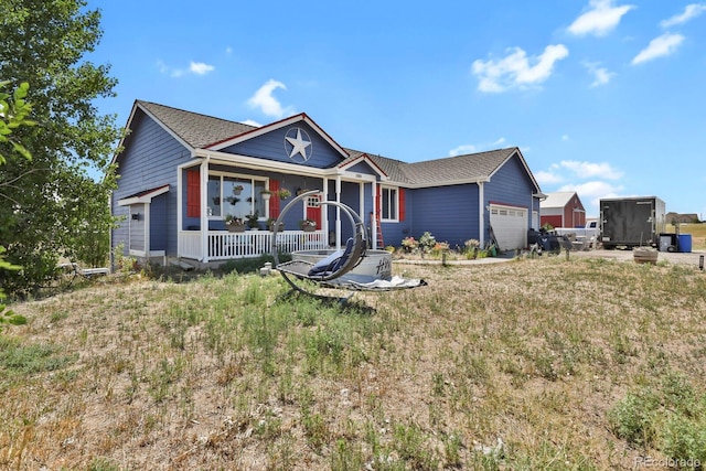 single story home with a porch and a garage