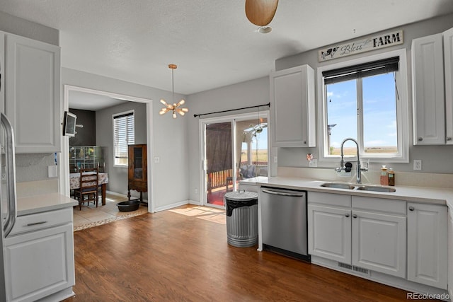 kitchen with white cabinetry, dishwasher, pendant lighting, and sink