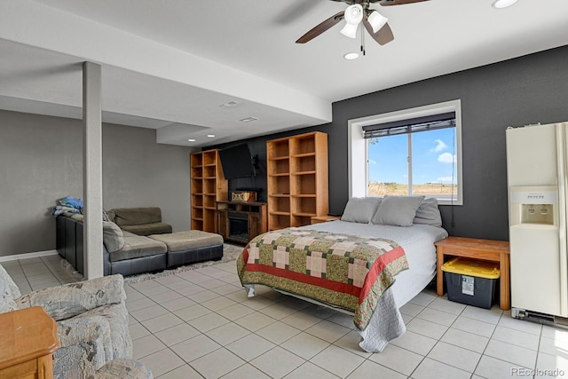 tiled bedroom with ceiling fan and white fridge with ice dispenser