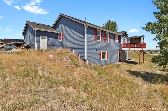 view of side of home with a wooden deck