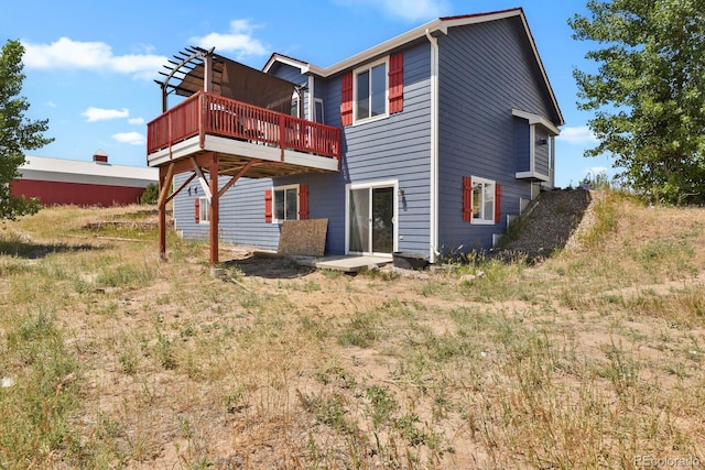 back of property featuring a wooden deck