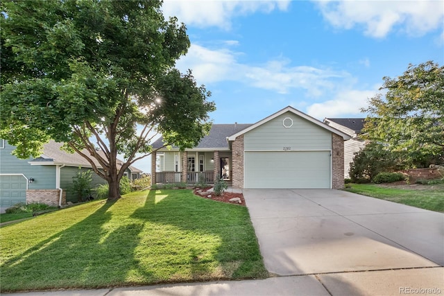 view of front of house featuring a garage, a front yard, and covered porch