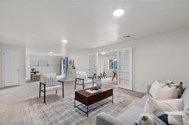 carpeted living room with french doors