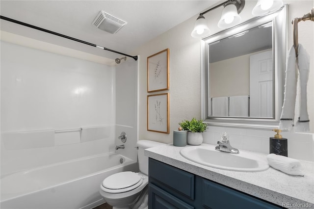 full bathroom featuring vanity, backsplash, bathing tub / shower combination, and toilet