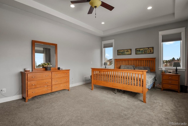 bedroom featuring carpet, multiple windows, and ceiling fan