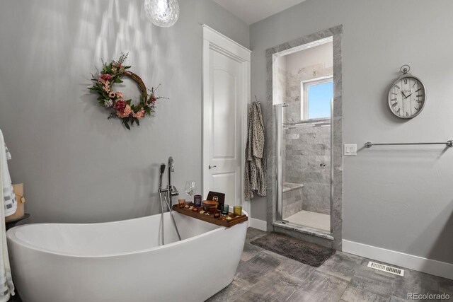 bathroom with shower with separate bathtub