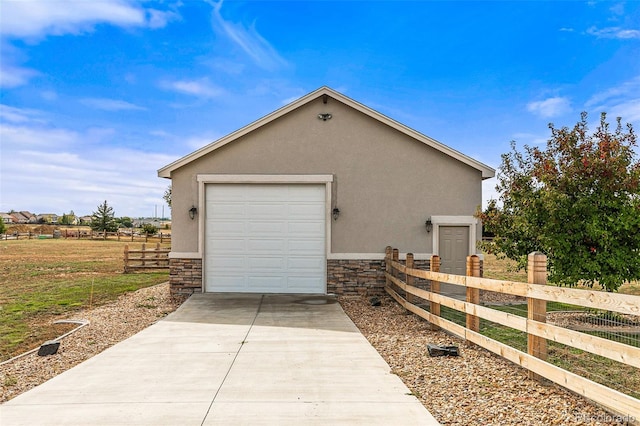 view of side of home featuring a garage and an outdoor structure