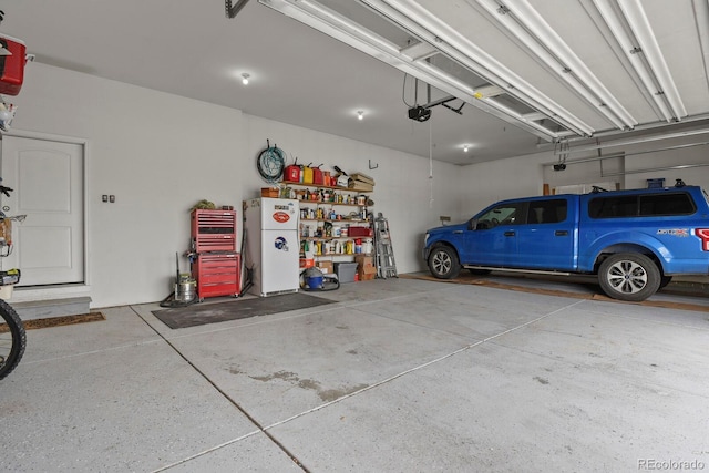 17155 Primrose Ln, Mead, CO 80542 - garage with freestanding refrigerator and a garage door opener