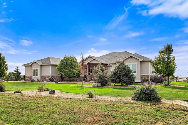 17155 Primrose Ln, Mead, CO 80542 - view of front facade featuring stucco siding, stone siding, and a front lawn