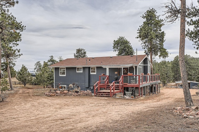 back of property featuring a wooden deck