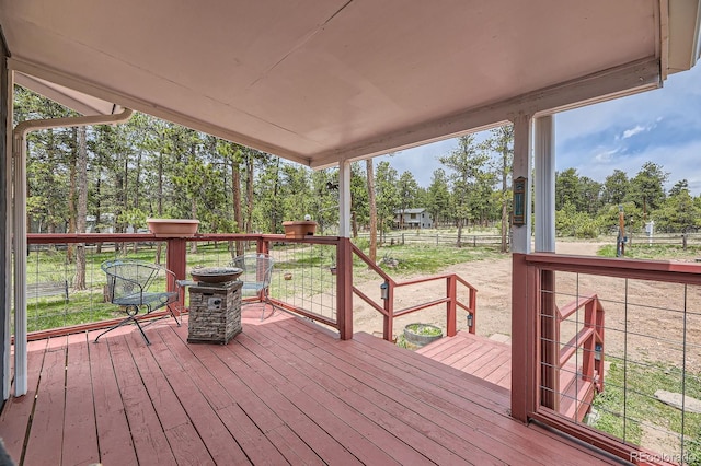 34886 Mohawk Trl, Pine, CO 80470 - wooden terrace featuring view of wooded area