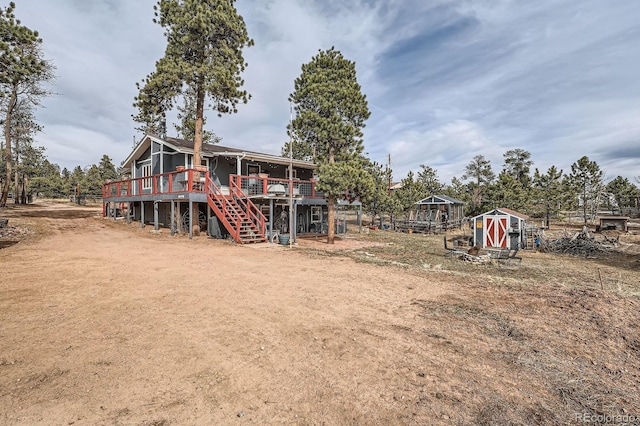 34886 Mohawk Trl, Pine, CO 80470 - back of house featuring stairs, a wooden deck, and an outdoor structure