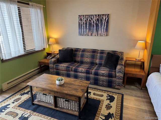 living room featuring baseboard heating and wood finished floors