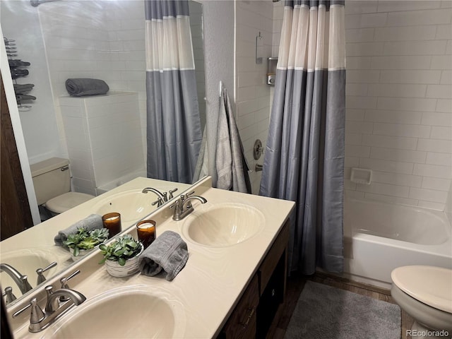 bathroom with a sink, toilet, and shower / bathtub combination with curtain