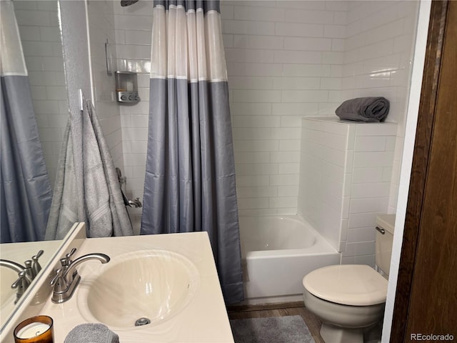 bathroom with toilet, shower / tub combo with curtain, and vanity