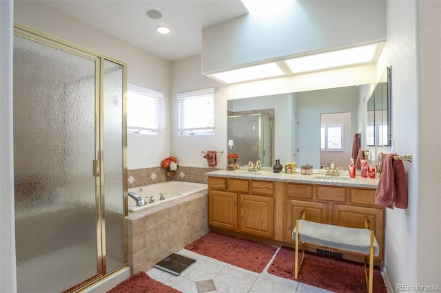 bathroom featuring a wealth of natural light, separate shower and tub, vanity, and tile patterned floors