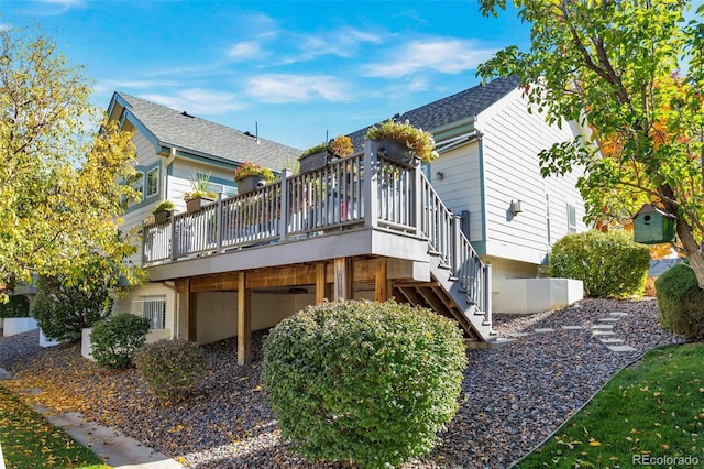 rear view of property featuring a wooden deck