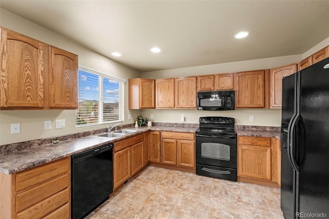 kitchen with black appliances, a sink, recessed lighting, and dark countertops