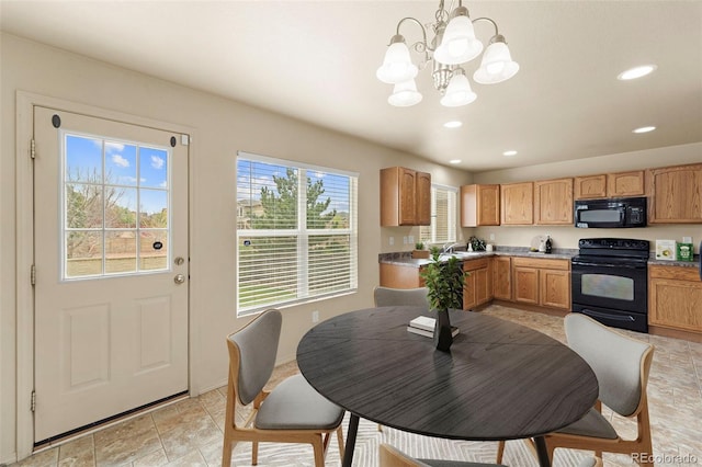 kitchen featuring black appliances, a chandelier, recessed lighting, a sink, and pendant lighting